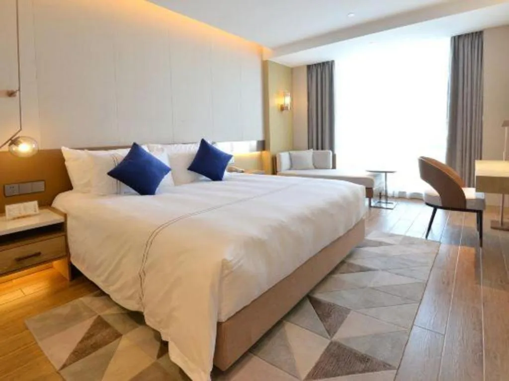 Bed in AUGUSTINE HOTEL