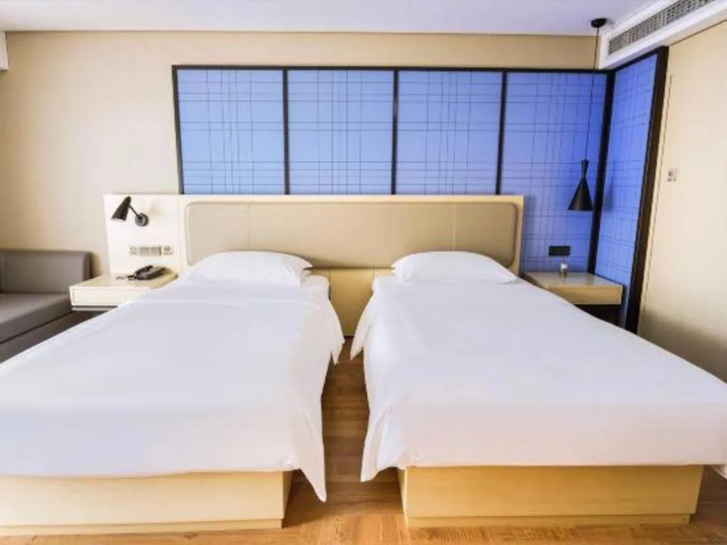 Bed in Echarm Hotel Aegean Shopping Park Zhonghuan Plaza