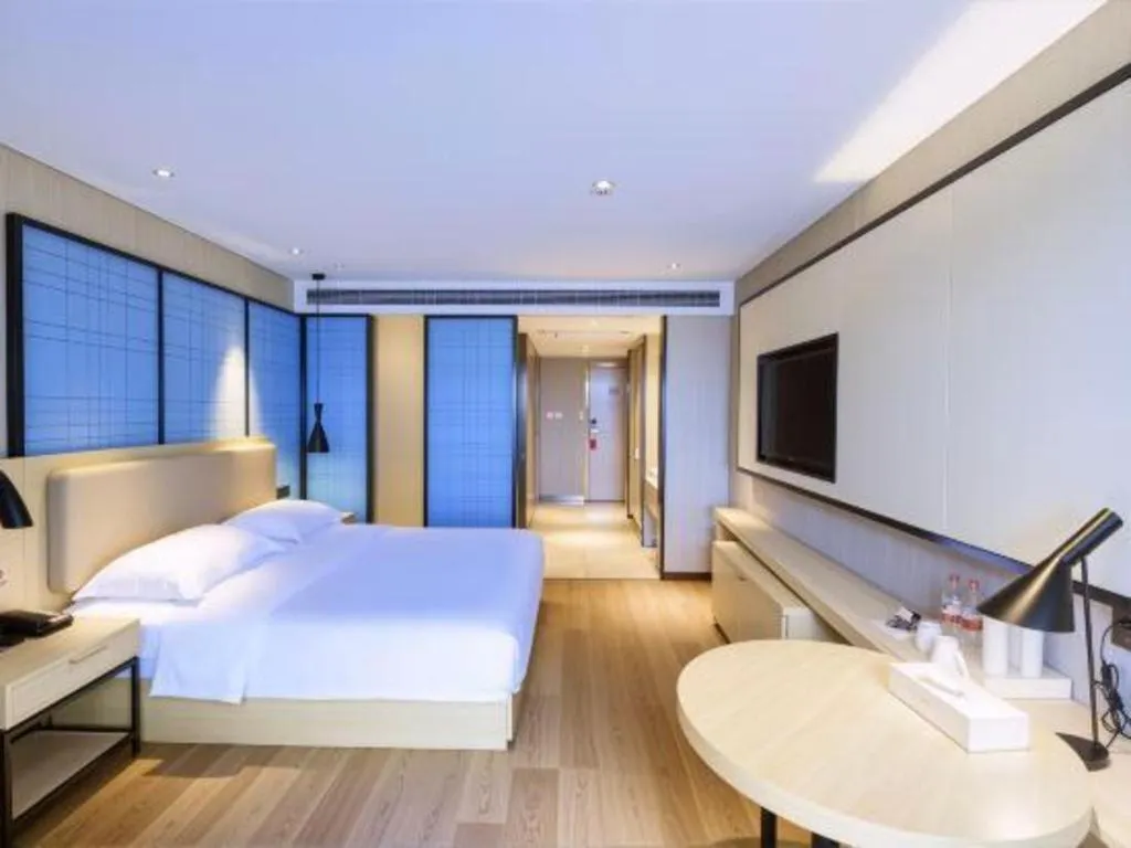 Bed in Echarm Hotel Aegean Shopping Park Zhonghuan Plaza