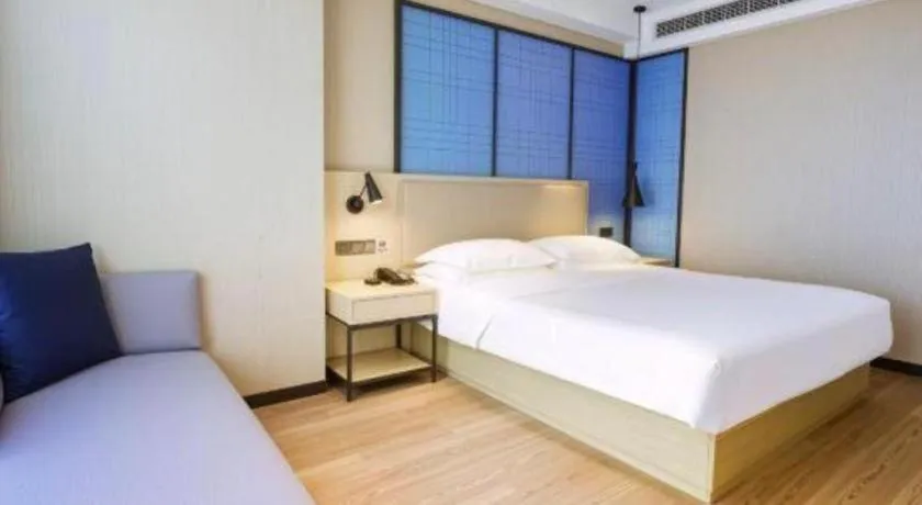 Bed in Echarm Hotel Aegean Shopping Park Zhonghuan Plaza