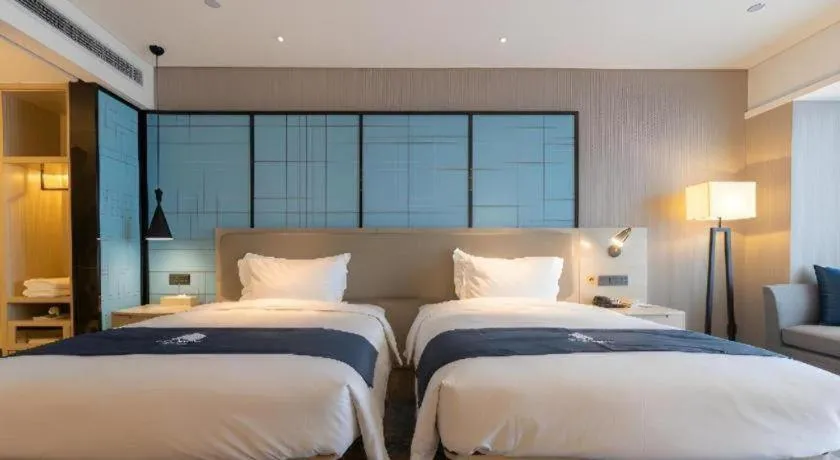 Bed in Echarm Hotel Aegean Shopping Park Zhonghuan Plaza