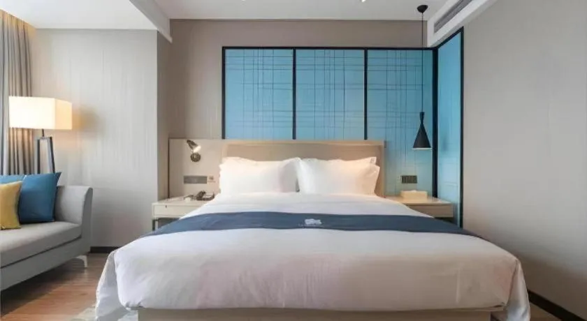Bed in Echarm Hotel Aegean Shopping Park Zhonghuan Plaza