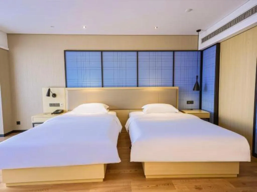 Bed in Echarm Hotel Aegean Shopping Park Zhonghuan Plaza