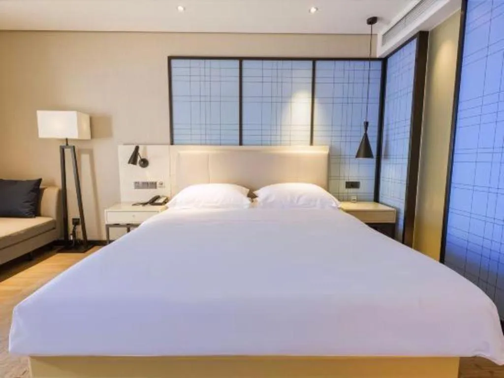 Bed in Echarm Hotel Aegean Shopping Park Zhonghuan Plaza