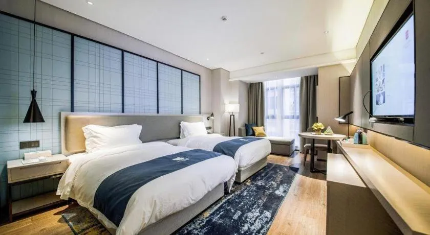 Bed in Echarm Hotel Aegean Shopping Park Zhonghuan Plaza