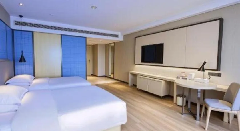 Bed in Echarm Hotel Aegean Shopping Park Zhonghuan Plaza