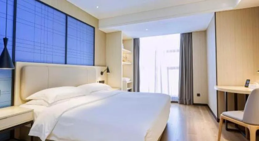 Bed in Echarm Hotel Aegean Shopping Park Zhonghuan Plaza