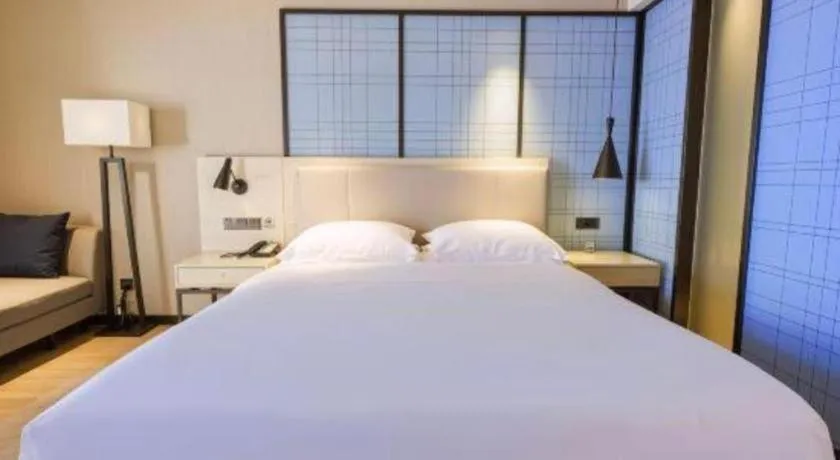 Bed in Echarm Hotel Aegean Shopping Park Zhonghuan Plaza