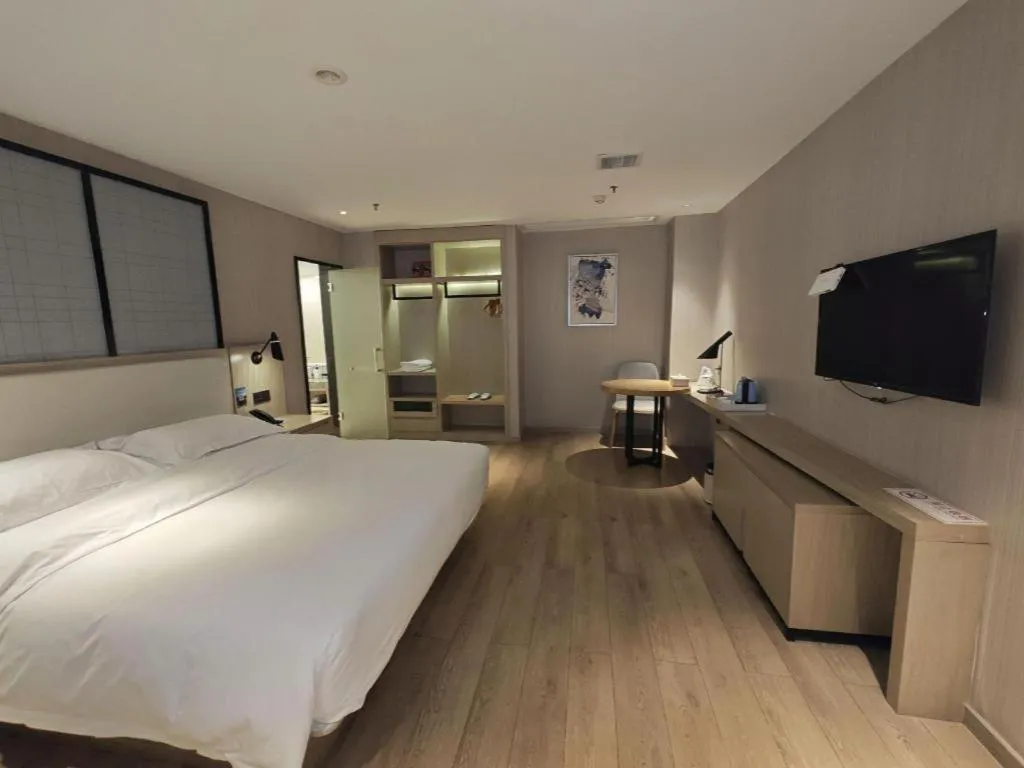 Bed in Echarm Hotel Xinyu Railway Station Baoshi Park
