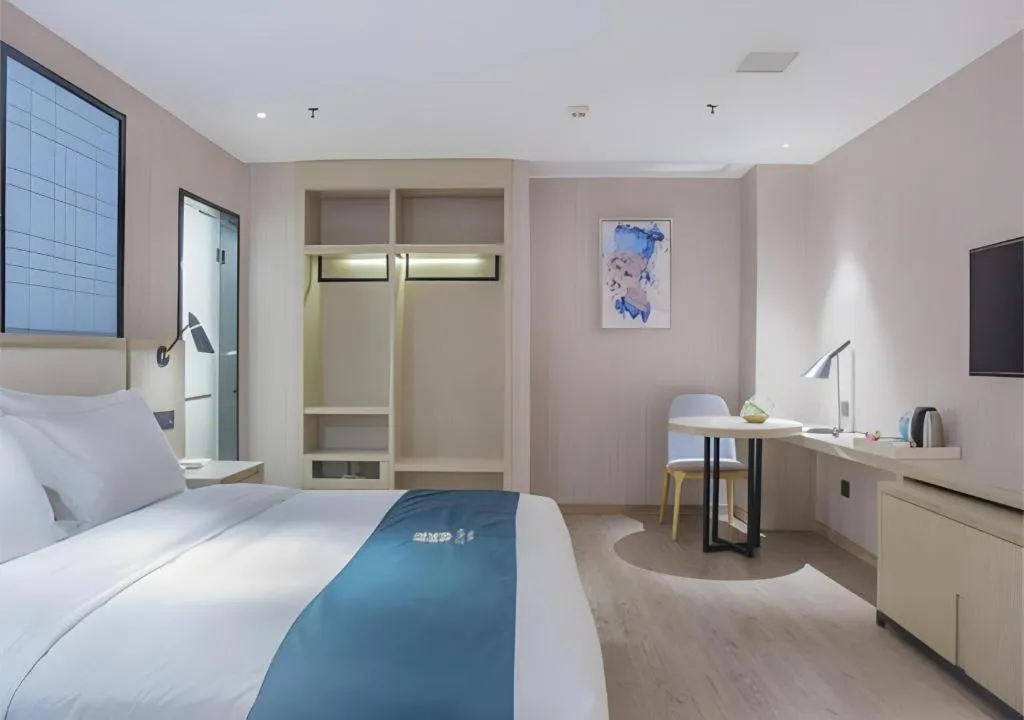 Bed in Echarm Hotel Xinyu Railway Station Baoshi Park