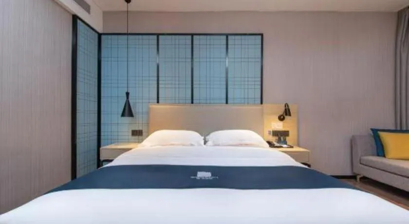 Bed in Echarm Hotel Xinyu Railway Station Baoshi Park