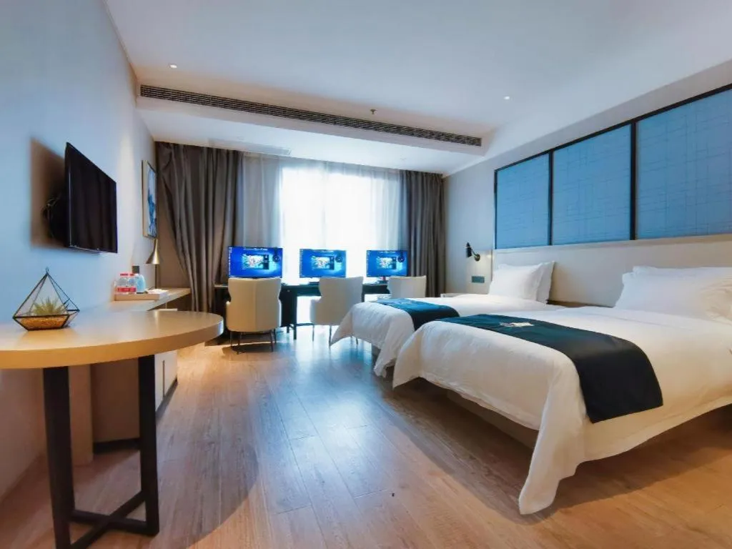 Bed in Echarm Hotel Xinyu Railway Station Baoshi Park