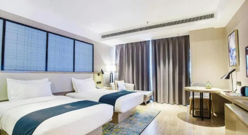 Bed in Echarm Hotel Xinyu Railway Station Baoshi Park