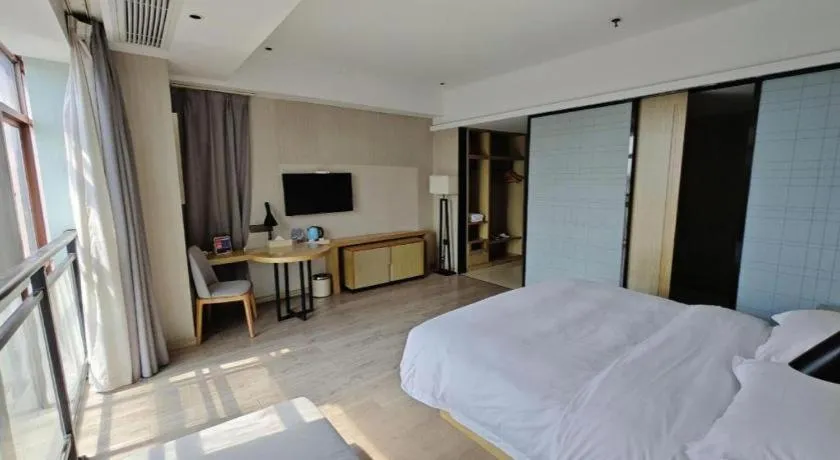 Bed in Echarm Hotel Xinyu Railway Station Baoshi Park