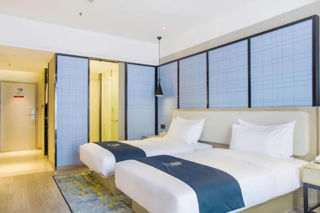 Bed in Echarm Hotel Xinyu Railway Station Baoshi Park