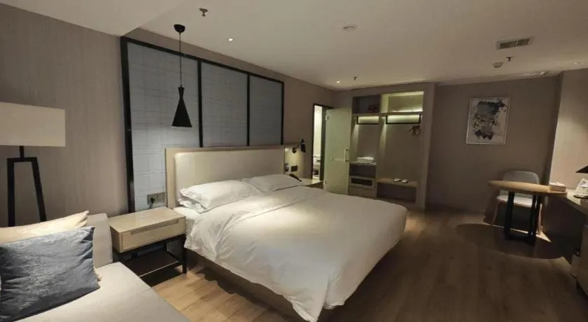 Bed in Echarm Hotel Xinyu Railway Station Baoshi Park