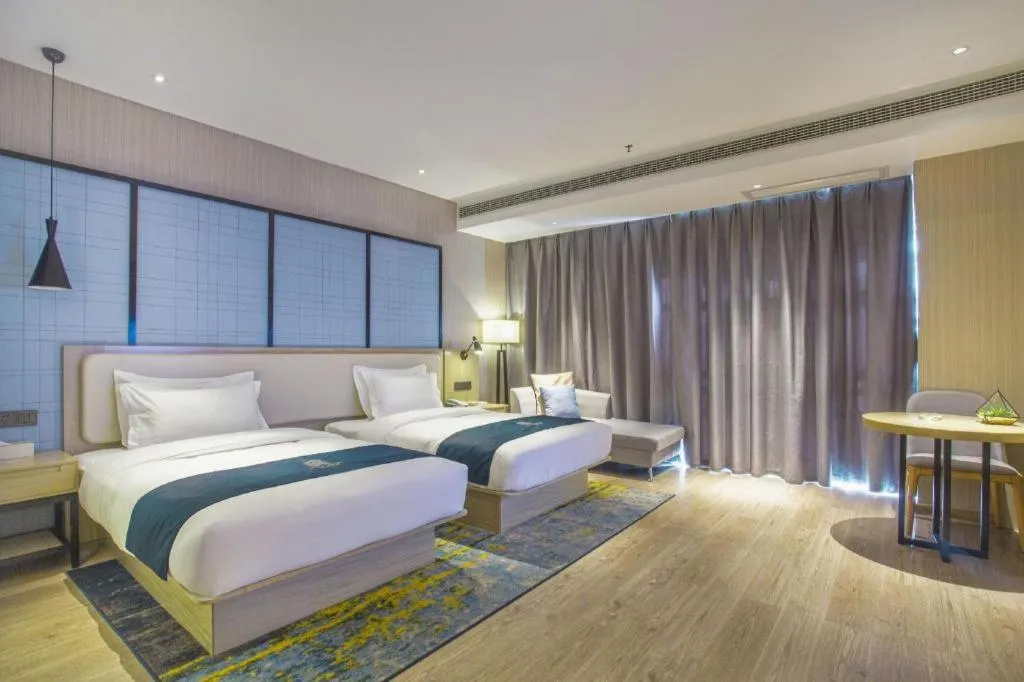 Bed in Echarm Hotel Xinyu Railway Station Baoshi Park