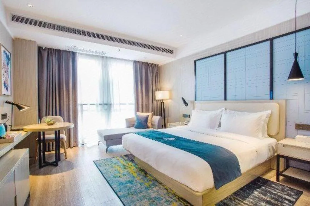 Bed in Echarm Hotel Xinyu Railway Station Baoshi Park