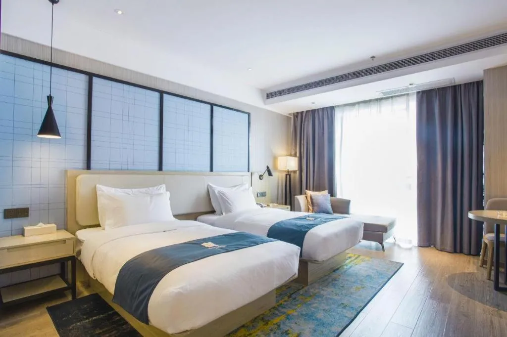 Bed in Echarm Hotel Xinyu Railway Station Baoshi Park