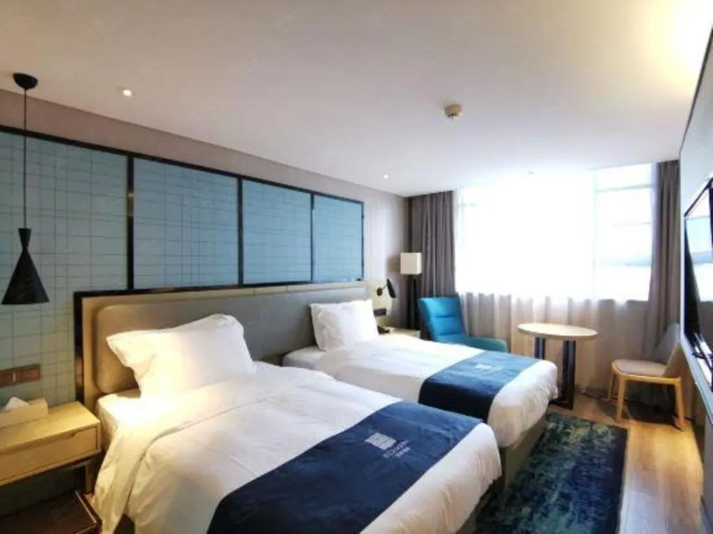 Bed in Echarm Hotel Wuhan Vanke Future Center Wulidun Metro Station