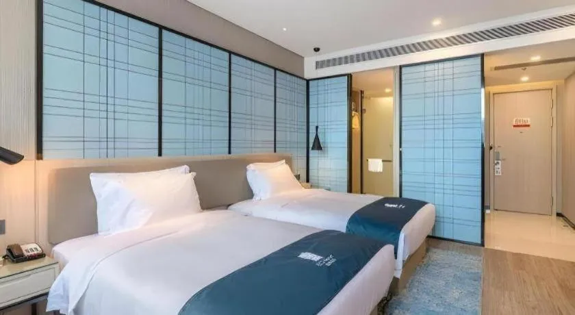 Bed in Echarm Hotel Kunming Railway Station Huancheng South Road Metro Station