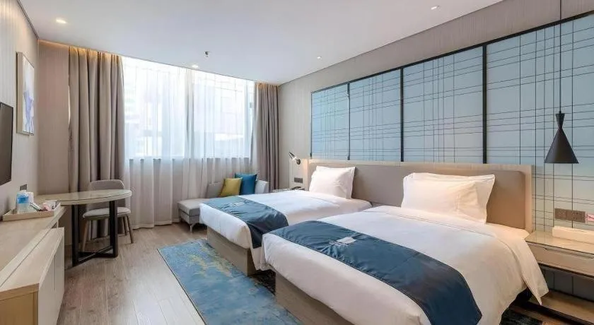 Bed in Echarm Hotel Kunming Railway Station Huancheng South Road Metro Station