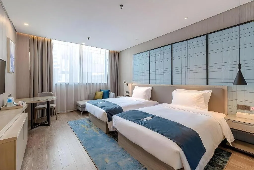 Bed in Echarm Hotel Kunming Railway Station Huancheng South Road Metro Station