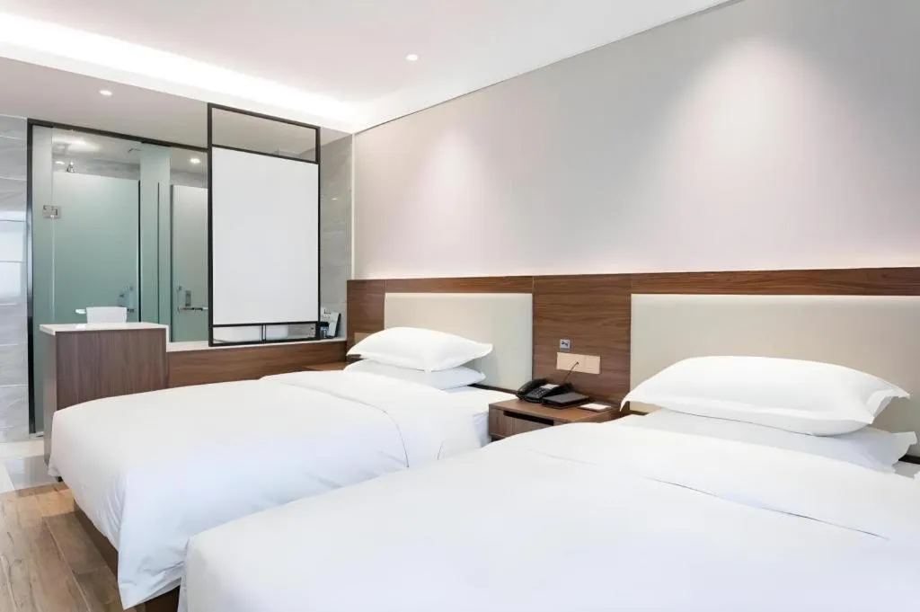 Bed in Borrman Hotel East Huai'an Railway Station Zhou 'Enlai Memorial