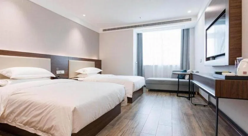 Bed in Borrman Hotel East Huai'an Railway Station Zhou 'Enlai Memorial