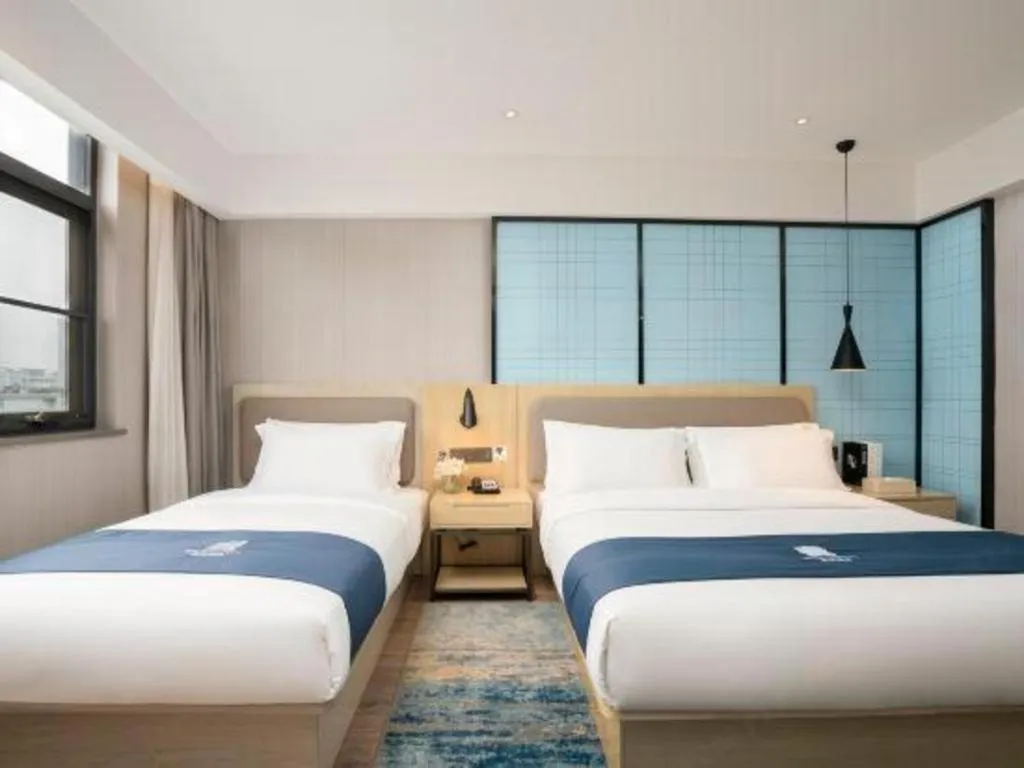 Bed in Echarm Hotel Jianshui Gucheng