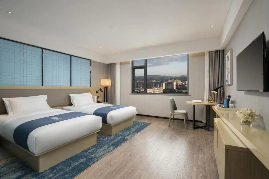 Bed in Echarm Hotel Jianshui Gucheng