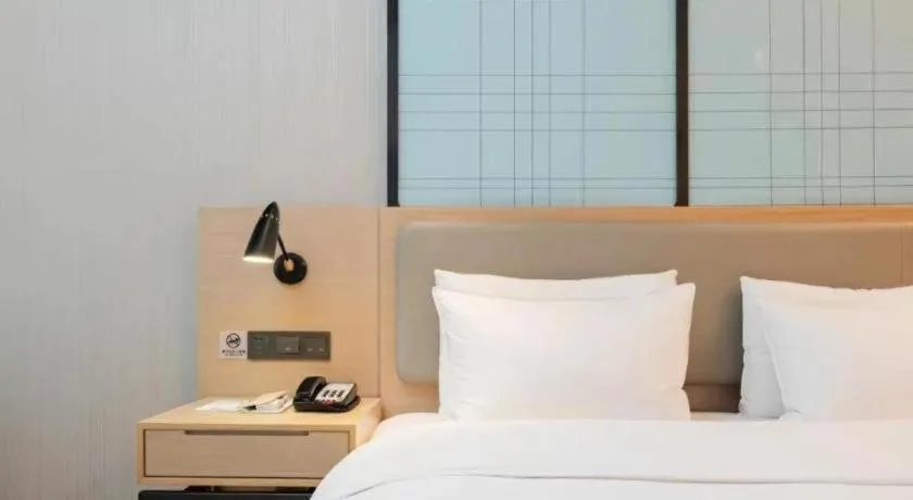 Bed in Echarm Hotel Liuzhou Liunan Wanda Plaza