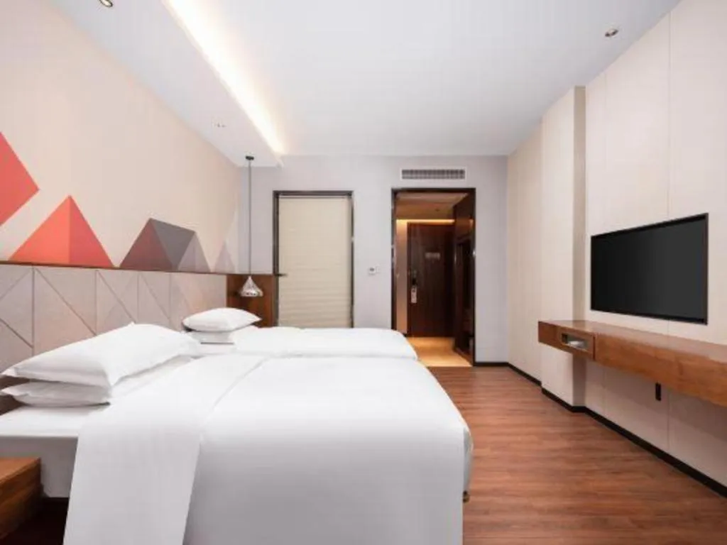 Bed in Borrman Hotel Qianjiang High-speed Railway Station Lobster City