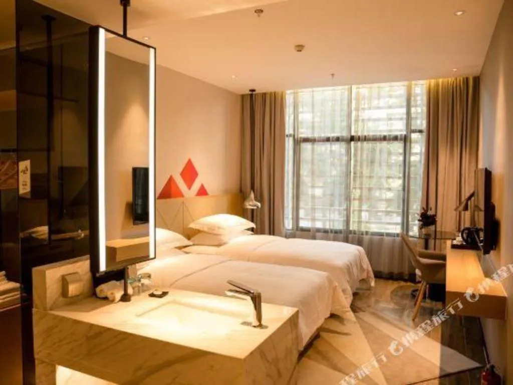 Bed in Borrman Hotel Qianjiang High-speed Railway Station Lobster City