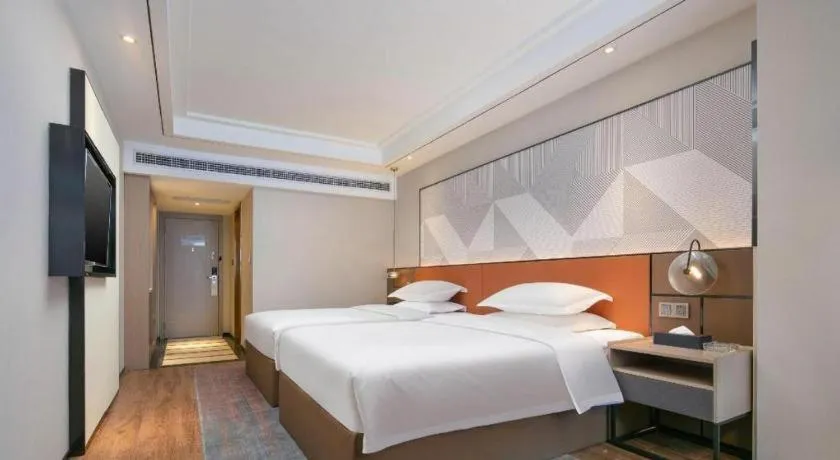 Bed in Borrman Hotel Qianjiang High-speed Railway Station Lobster City