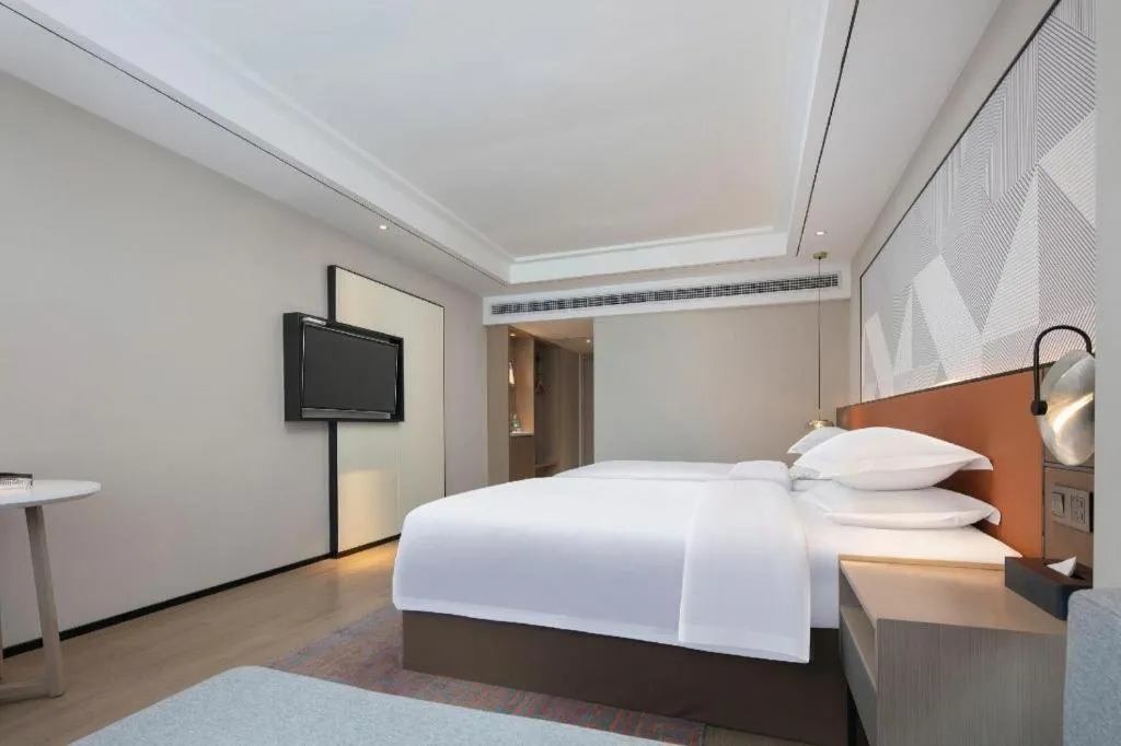 Bed in Borrman Hotel Qianjiang High-speed Railway Station Lobster City