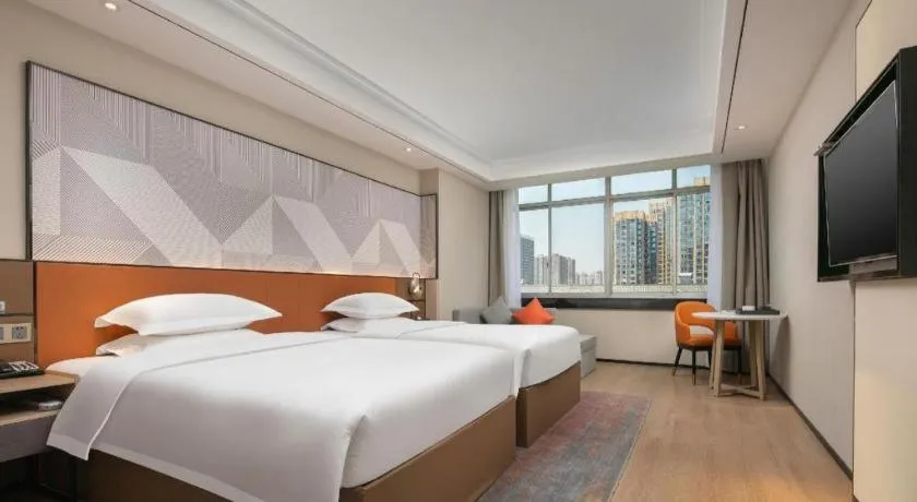 Bed in Borrman Hotel Qianjiang High-speed Railway Station Lobster City