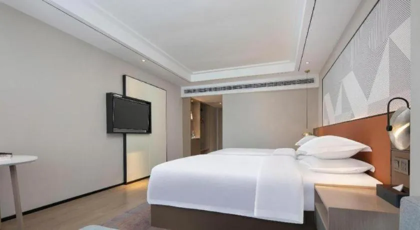 Bed in Borrman Hotel Qianjiang High-speed Railway Station Lobster City