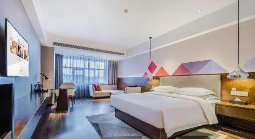 Bed in Borrman Hotel Qianjiang High-speed Railway Station Lobster City