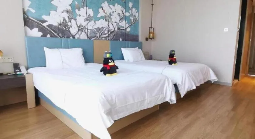 Bed in Magnotel Tongxiang Shimao Center