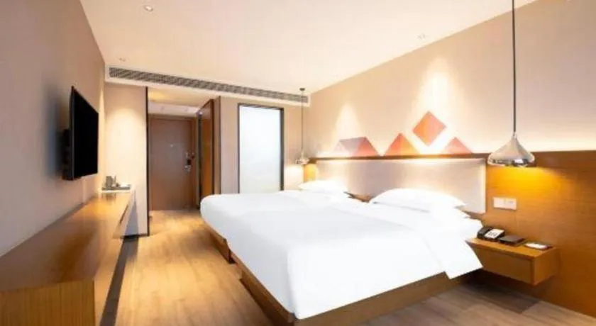 Bed in Borrman Hotel Zhanjiang Wuchuan Jinsha Plaza