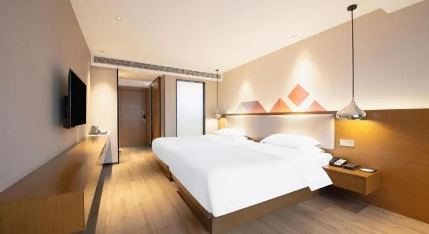 Bed in Borrman Hotel Zhanjiang Wuchuan Jinsha Plaza