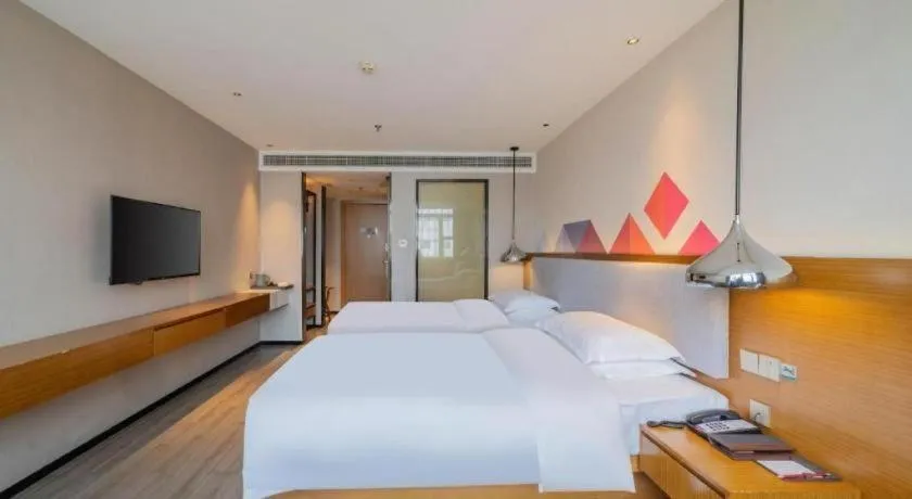 Bed in Borrman Hotel Zhanjiang Wuchuan Jinsha Plaza