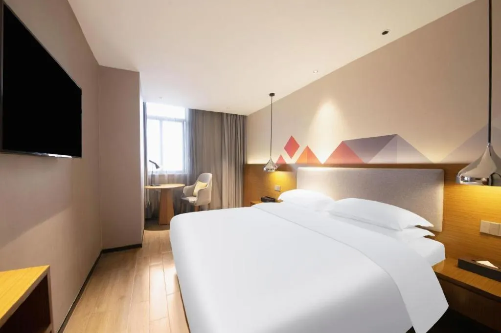 Bed in Borrman Hotel Zhanjiang Wuchuan Jinsha Plaza