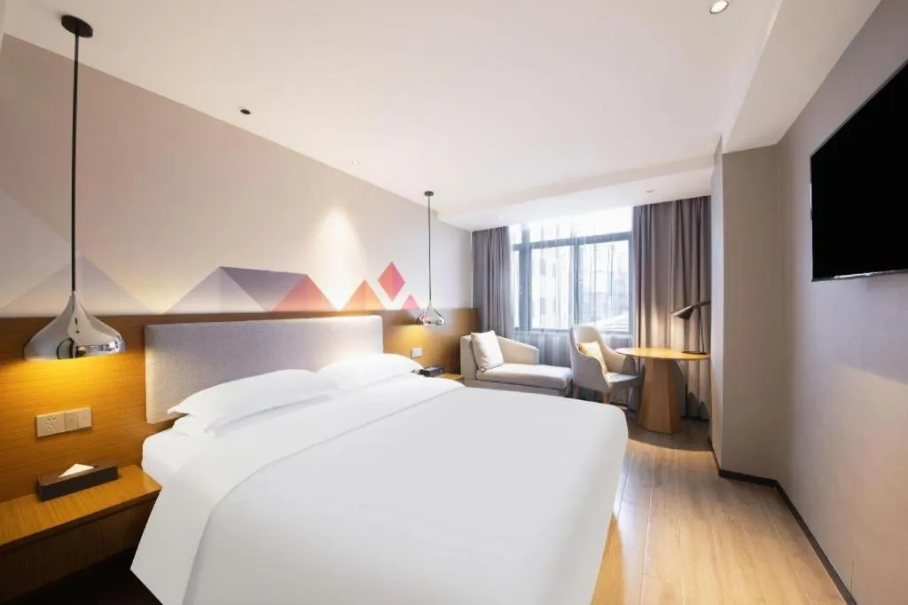 Bed in Borrman Hotel Zhanjiang Wuchuan Jinsha Plaza