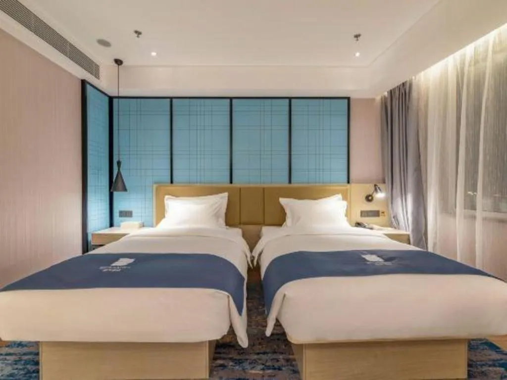 Bed in Echarm Hotel Tai'an Taishan Tianwai Village Hongmen