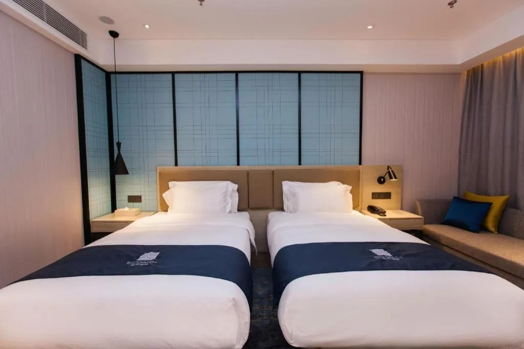 Bed in Echarm Hotel Tai'an Taishan Tianwai Village Hongmen