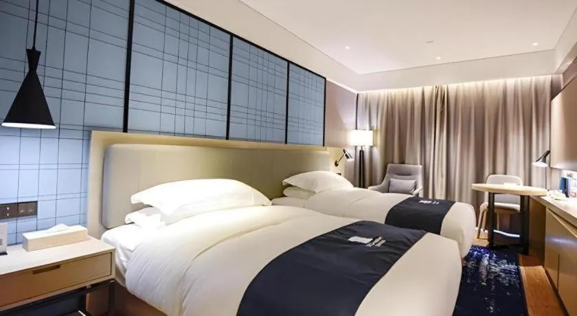 Bed in Echarm Hotel Kunming High-speed Railway South Station Chunrong Street Metro Station