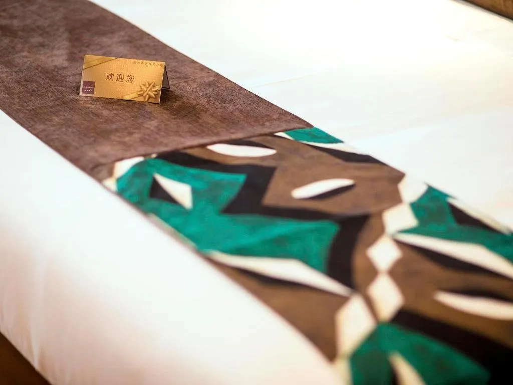 Bed in James Joyce Coffetel Xinyang Municipal Government Railway Station