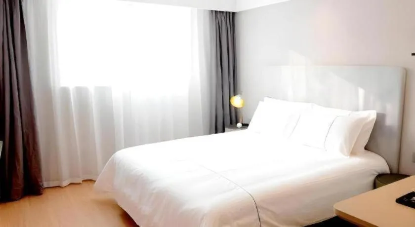 Bed in Magnotel Hotel Xuzhou Xinxin Yurun Plaza Zhongwu Road